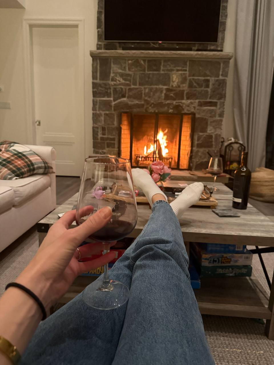 Cozy evening by the stone fireplace at The Westtown Reset — wine, board games, private estate retreat Hudson Valley upstate New York