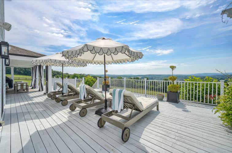 Wraparound deck with chaise lounges and panoramic Hudson Valley views at The Westtown Reset — private estate retreat upstate New York