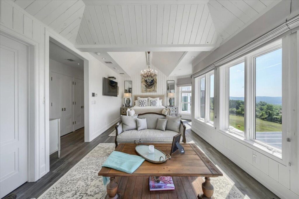 Primary bedroom suite at The Westtown Reset — chandelier, shiplap ceiling, valley views, en-suite luxury vacation rental upstate New York