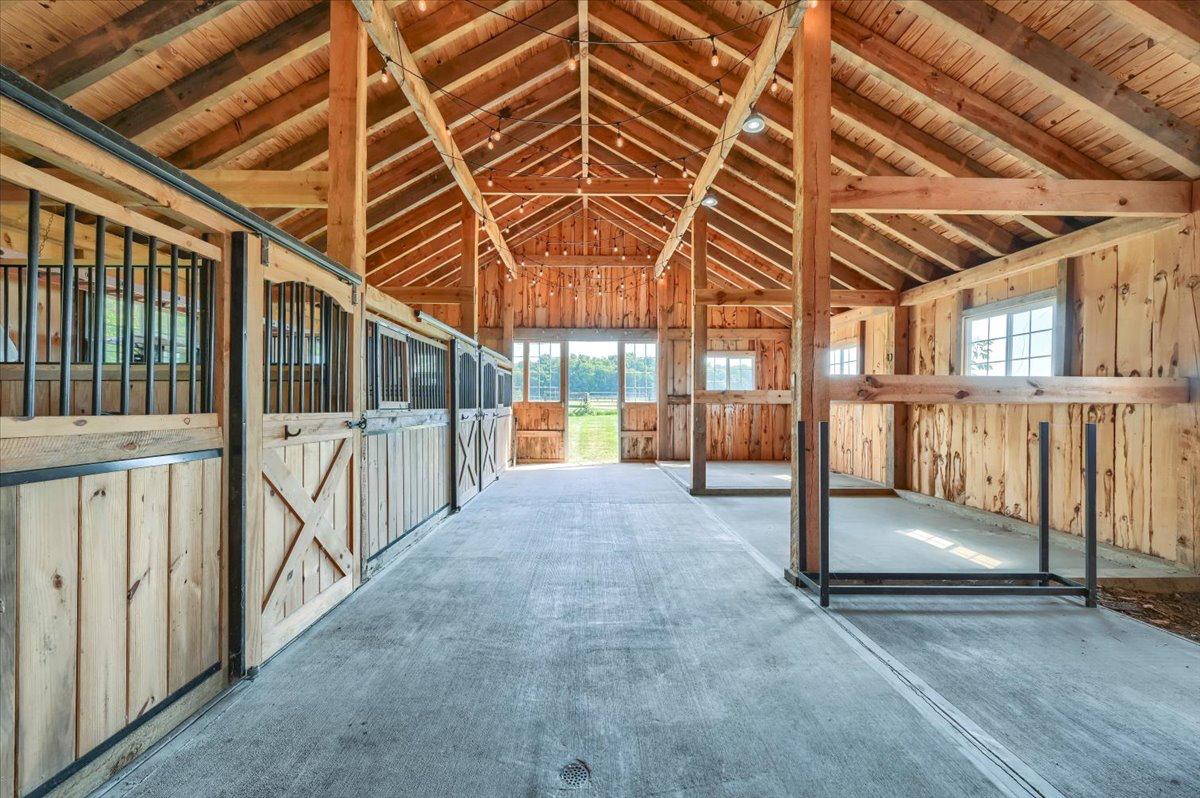 Red barn interior at The Westtown Reset — timber frame, string lights, event space upstate New York