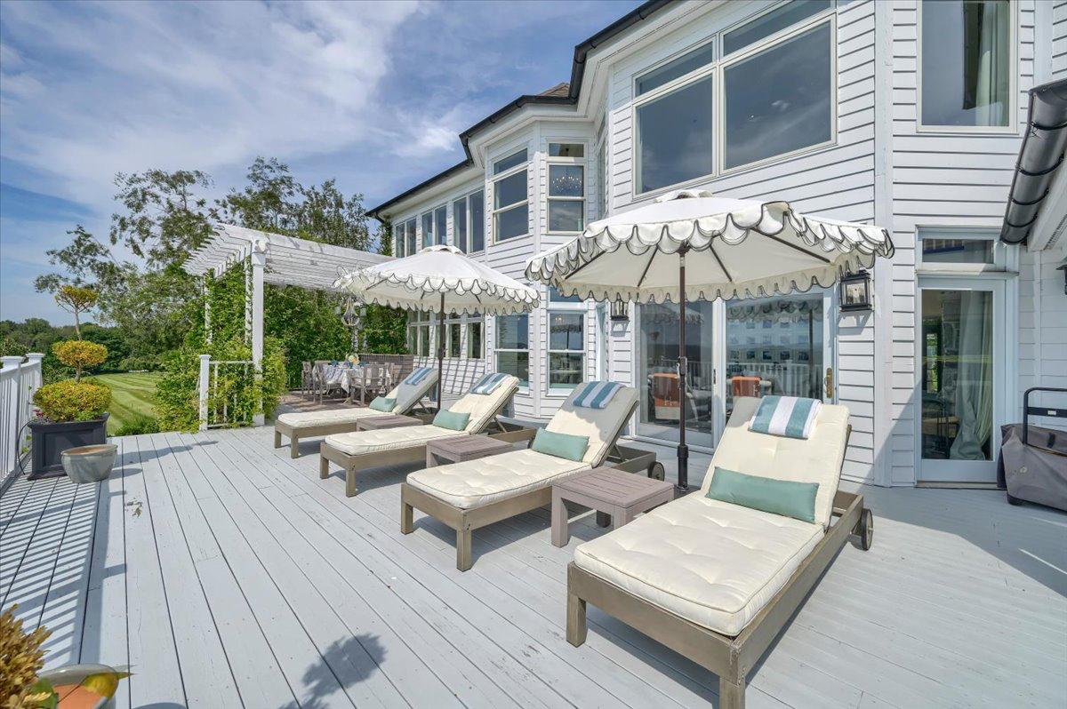 Wraparound deck with sun loungers and umbrellas at The Westtown Reset — private outdoor terrace, pergola and lawn views, luxury upstate New York vacation rental